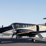 Beechcraft King Air B200 turboprop on an airport ramp at dusk, with close-up views of the nose and a twilight side view